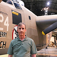 Scott Althaus beside a B-24, MIA research to find the final resting place of WWII Bombardier Lt. Thomas Kelly, his cousin once removed.